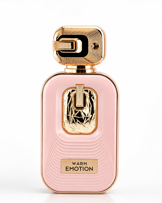 Noor Fragrances Warm Emotion perfume in a blush-pink bottle with gold textured cap and intricate metallic detailing.