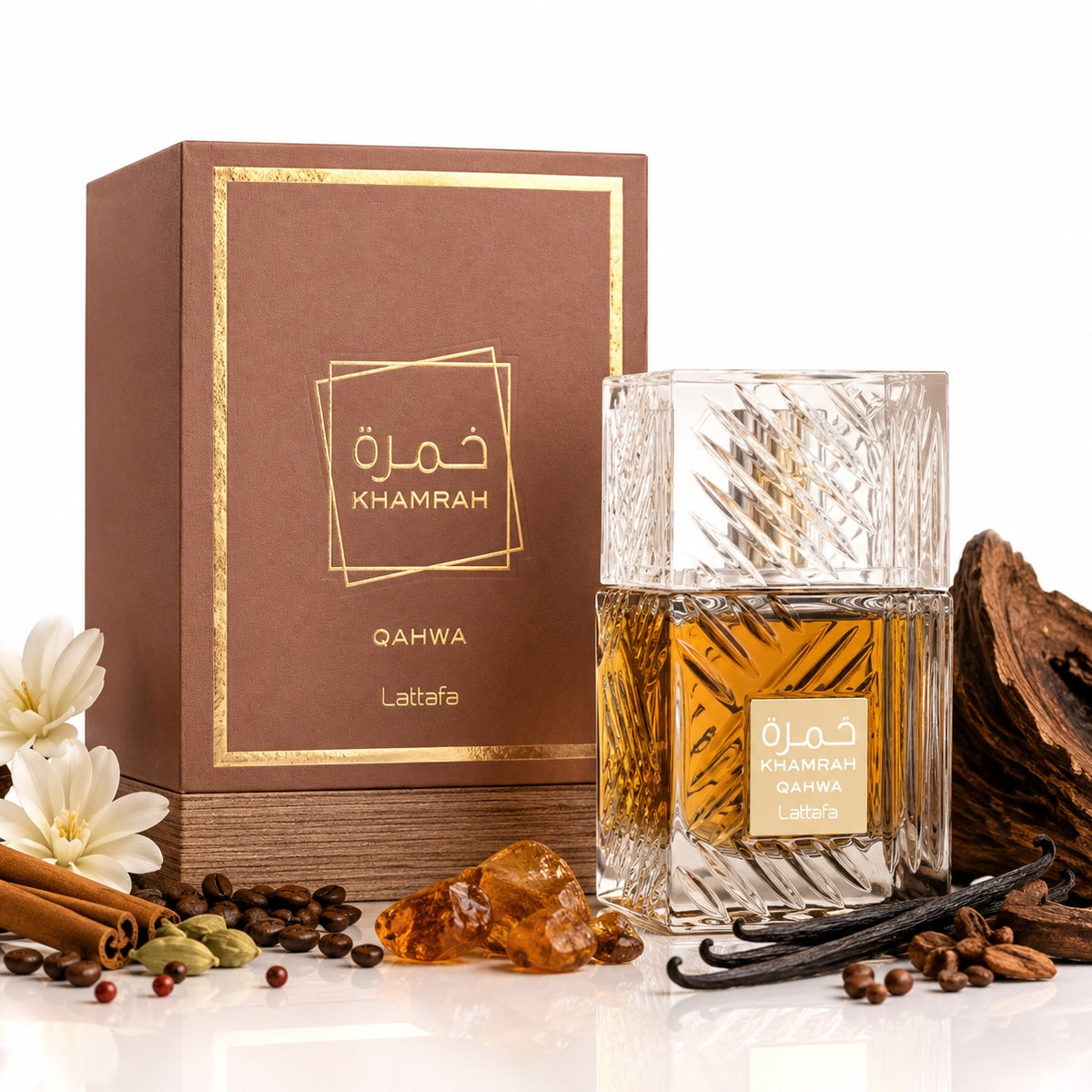 Noor Fragrances Lattafa Khamrah Qahwa eau de parfum in a crystal bottle next to its brown box with coffee and spices