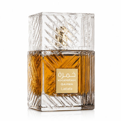 Noor Fragrances Lattafa Khamrah Qahwa eau de parfum in an intricately cut glass bottle with amber liquid.