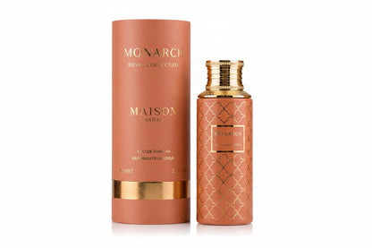 Noor Fragrances Maison Asrar Monarch perfume bottle and matching cylindrical box in terracotta with gold accents.