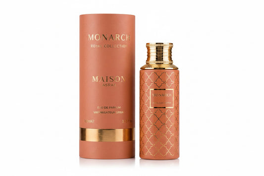 Noor Fragrances Maison Asrar Monarch perfume bottle and matching cylindrical box in terracotta with gold accents.