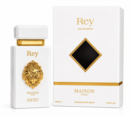 Noor Fragrances Maison Asrar Rey Eau de Parfum in a white bottle with a gold lion emblem next to its matching box.