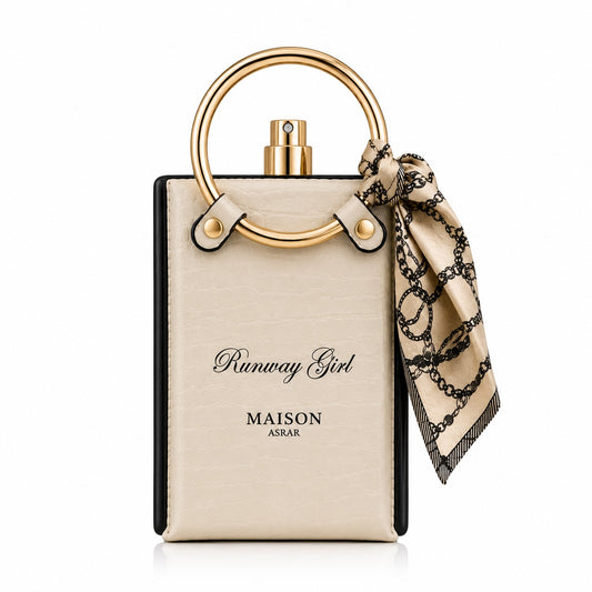 Noor Fragrances Runway Girl perfume in a cream textured bottle with a gold ring handle and printed scarf accessory.