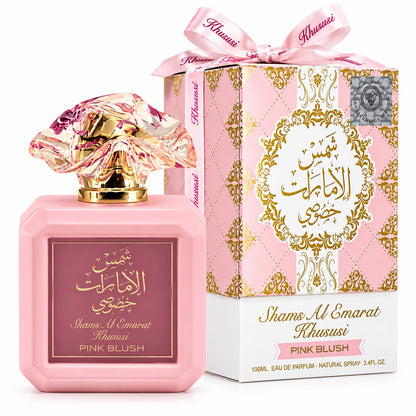 Noor Fragrances Shams Al Emarat Khususi Pink Blush perfume bottle with a sculpted cap and matching floral gift box.