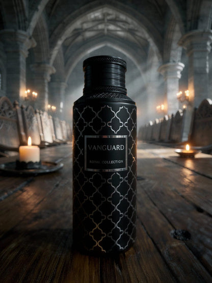 Noor Fragrances Vanguard Royal Collection perfume in a matte black bottle with silver geometric patterns on a table.